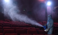 Unprecedented challenges ... a worker disinfects seats at a cinema in Delhi thumbnail