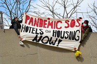 Demonstrators protesting over Homeless conditions with banner Over Nathan Philips Square in Toronto. thumbnail