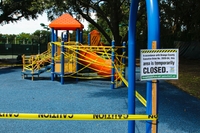 Outdoor Playground Closed Off By Caution Tape thumbnail