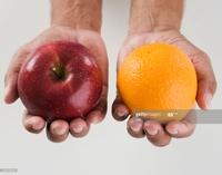 Close up of holding an apple and an orange thumbnail