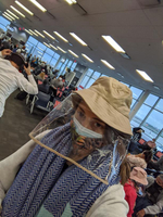 Passenger wearing multiple layer of PPE in the lounge at gate D40 at Toronto Pearson Airport (YYZ) thumbnail