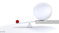Analogical image of two balls on a scale representing &quot;big and small&quot; thumbnail