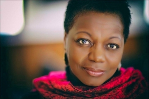 Photograph of Marva Wisdom wearing a red scarf.