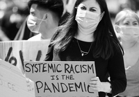 A Sign that Says Systemic Racism is a Pandemic at a Protest thumbnail